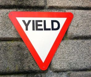 A Red and White Triangular Sign at an Intersection Means